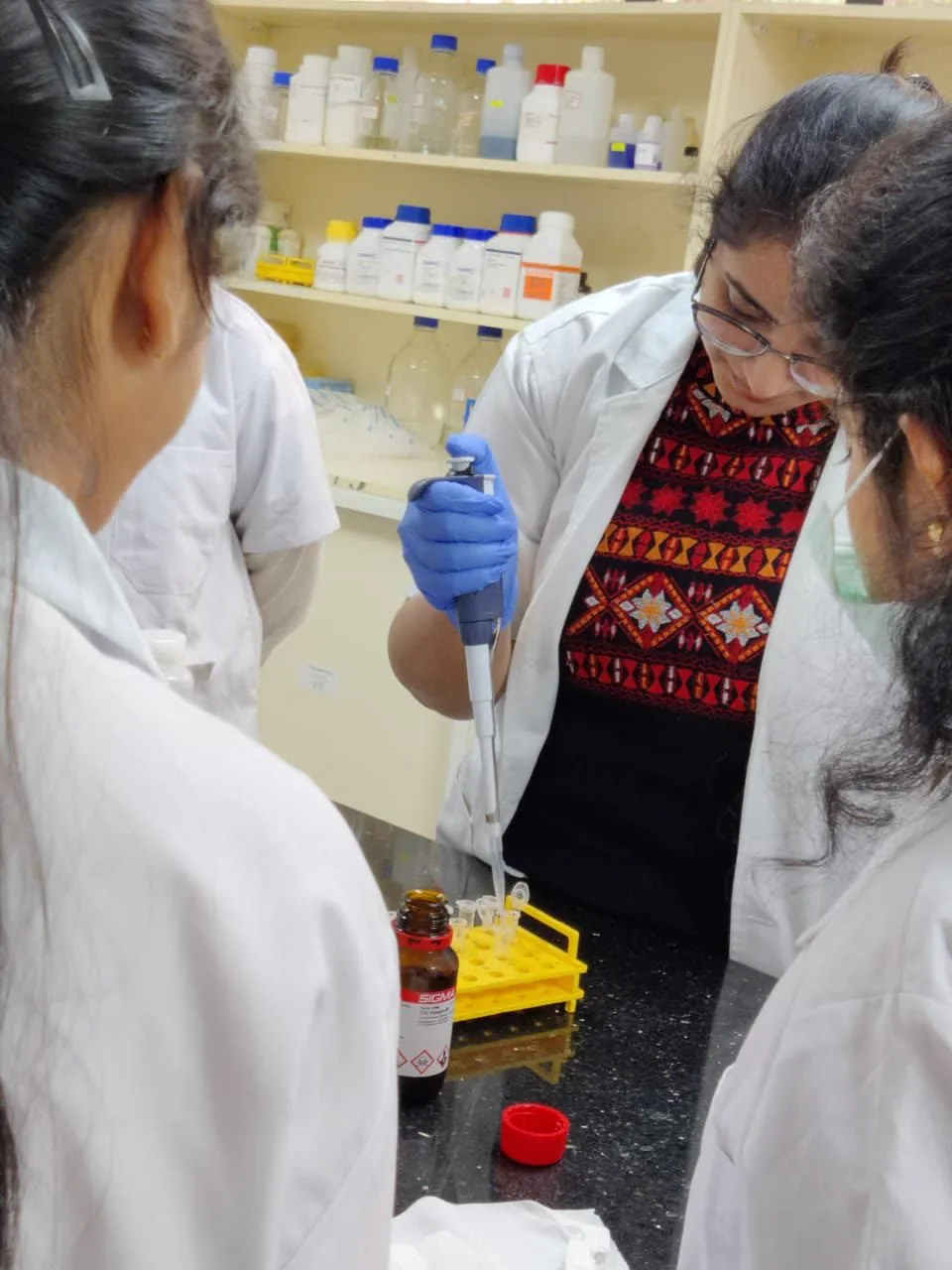 Interns pipetting samples in the Azooka lab